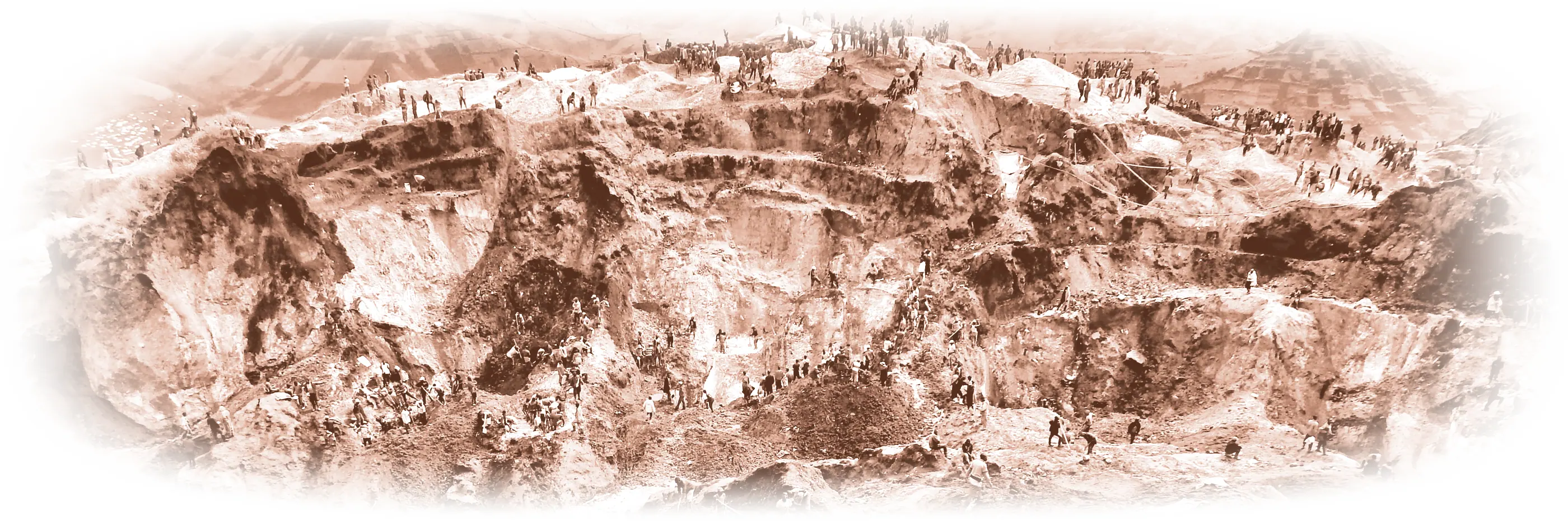 Photograph of an artisanal open-pit mine in North Kivu, DRC, with miners working the terraces